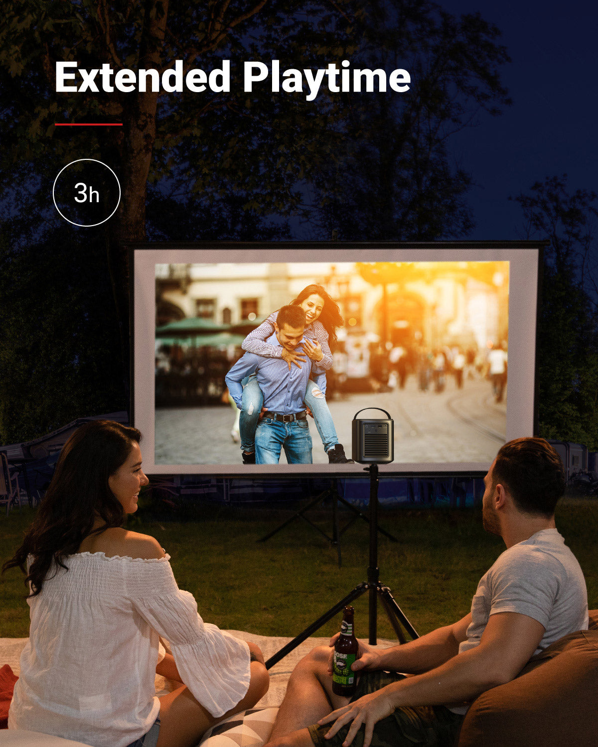 A couple sits in their backyard at night using a Nebula Mars 2 Pro portable projector on a stand to watch a romantic movie.